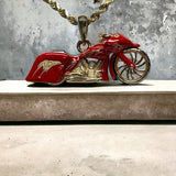 14k YG motorcycle pendant with red enamel and a diamond breather